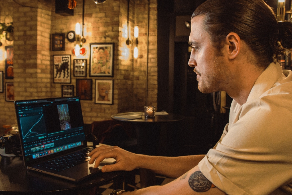 A man looks at a computer screen, analyzing data.